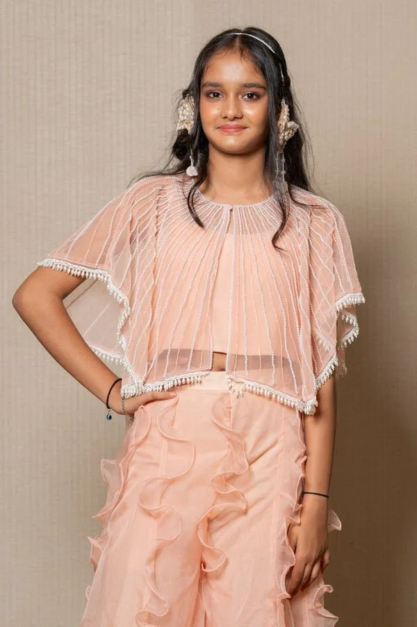 Chic Peach ensemble with beaded cape and ruffled palazzo pants, perfect for a stylish and elegant look at any occasion.